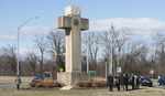 FILE - In this Feb. 13, 2019 file photo, visitors walk around the 40-foot Maryland Peace Cross dedicated to World War I soldiers in Bladensburg, Md. The Supreme Court says the World War I memorial in the shape of a 40-foot-tall cross can continue to stand on public land in Maryland. The high court on Thursday rejected a challenge to the nearly 100-year-old memorial. The justices ruled that its presence on public land doesn\'t violate the First Amendment\'s establishment clause. That clause prohibits the government from favoring one religion over others.(AP Photo/Kevin Wolf)