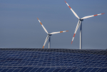 FILE -- Wind turbines turn behind a solar farm in Rapshagen, Germany, Thursday, Oct. 28, 2021. The German government presented a major package of reforms Wednesday to boost the construction of renewable power as part of its efforts to meet its climate goals and become independent of energy imports from hostile nations such as Russia. (AP Photo/Michael Sohn, file)
