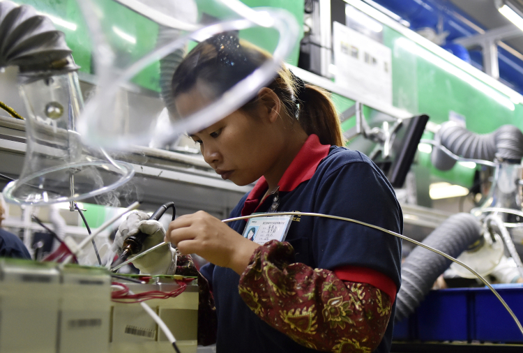 Worker at a lithium battery factory in China, 2015, AP