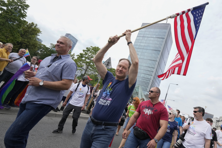 U.S. Ambassador Mark Brzezinski holds a U.S. flag as he marches in the yearly pride parade in Warsaw, Poland, on Saturday, June 17, 2023. AP