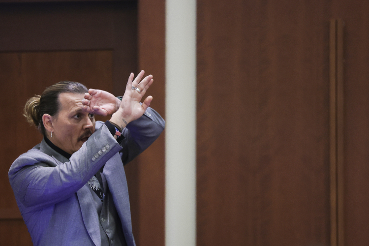 Actor Johnny Depp demonstrates how he claims he shielded himself from an alleged attack by his ex-wife Amber Heard. Reuters Pool