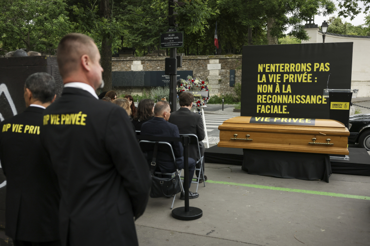 This protest in Paris mourns the death of privacy through AI surveillance technology. AP